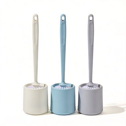 Three toilet brushes with cream, light blue, and light gray holders and matching long handles