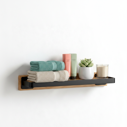 Oak and black wall shelf in a bathroom holding towels, skincare, plant, and candle