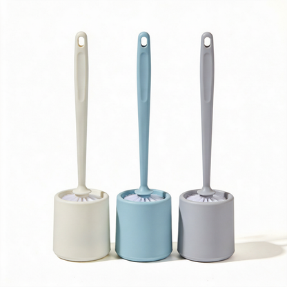 Three colorful toilet brushes with matching cylindrical holders on a white background