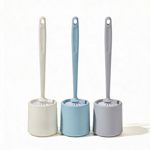 Three colorful toilet brushes with matching cylindrical holders on a white background